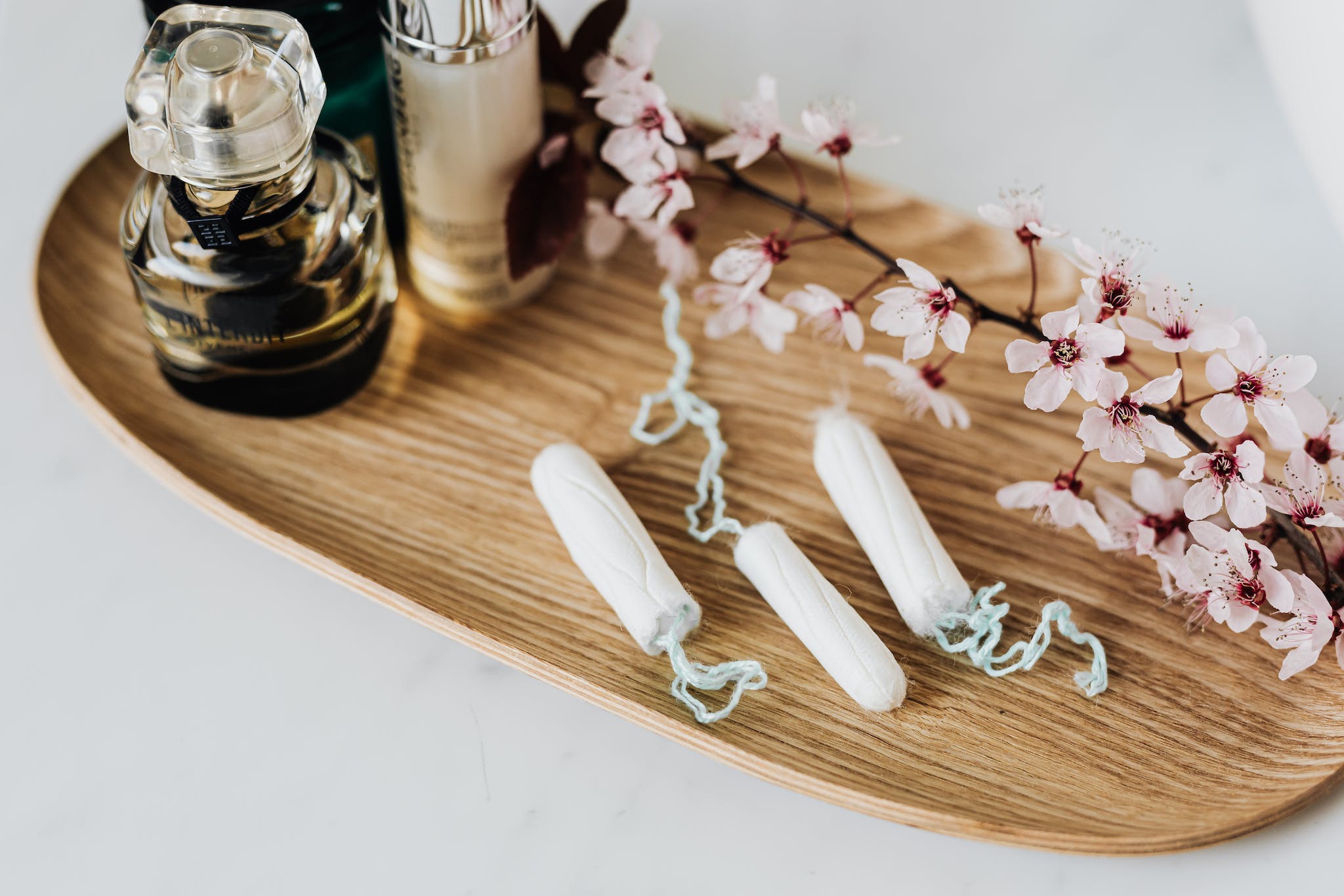 wooden tray with perfume cosmetic products hygienic